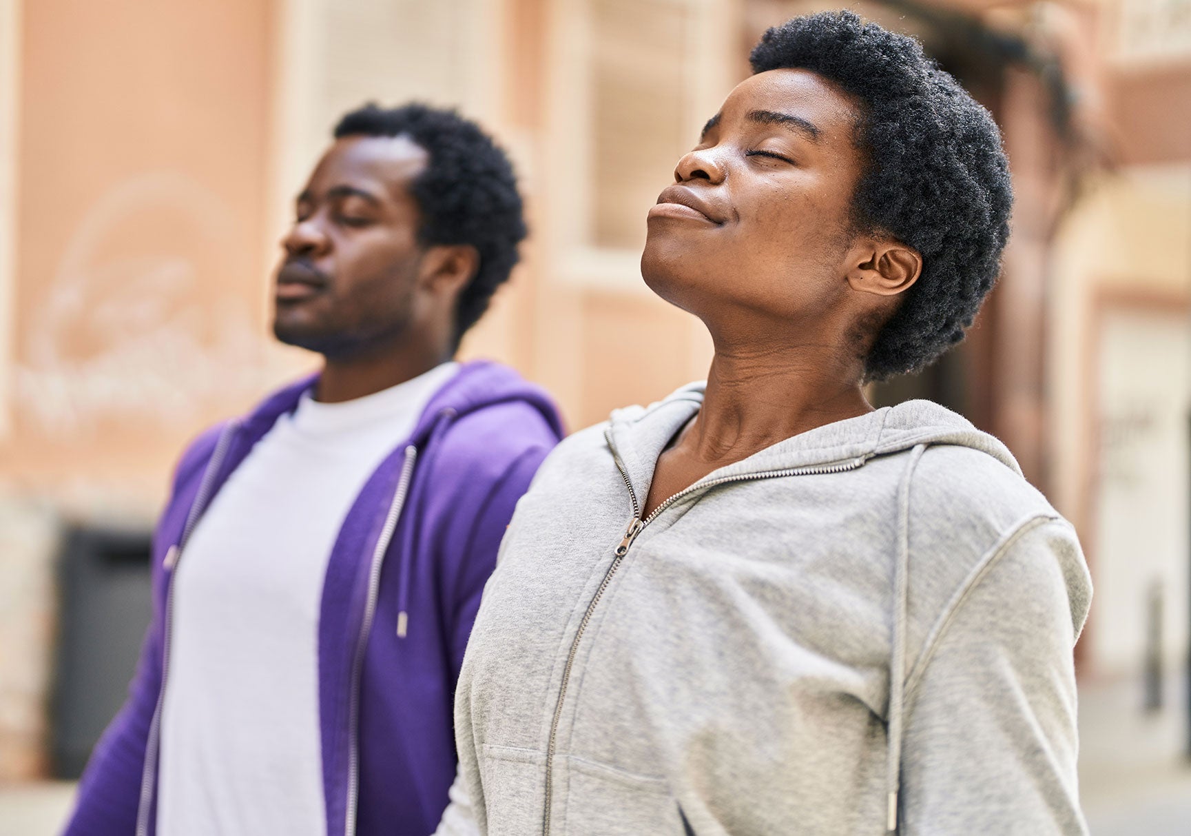 African american man and woman couple breathing at street