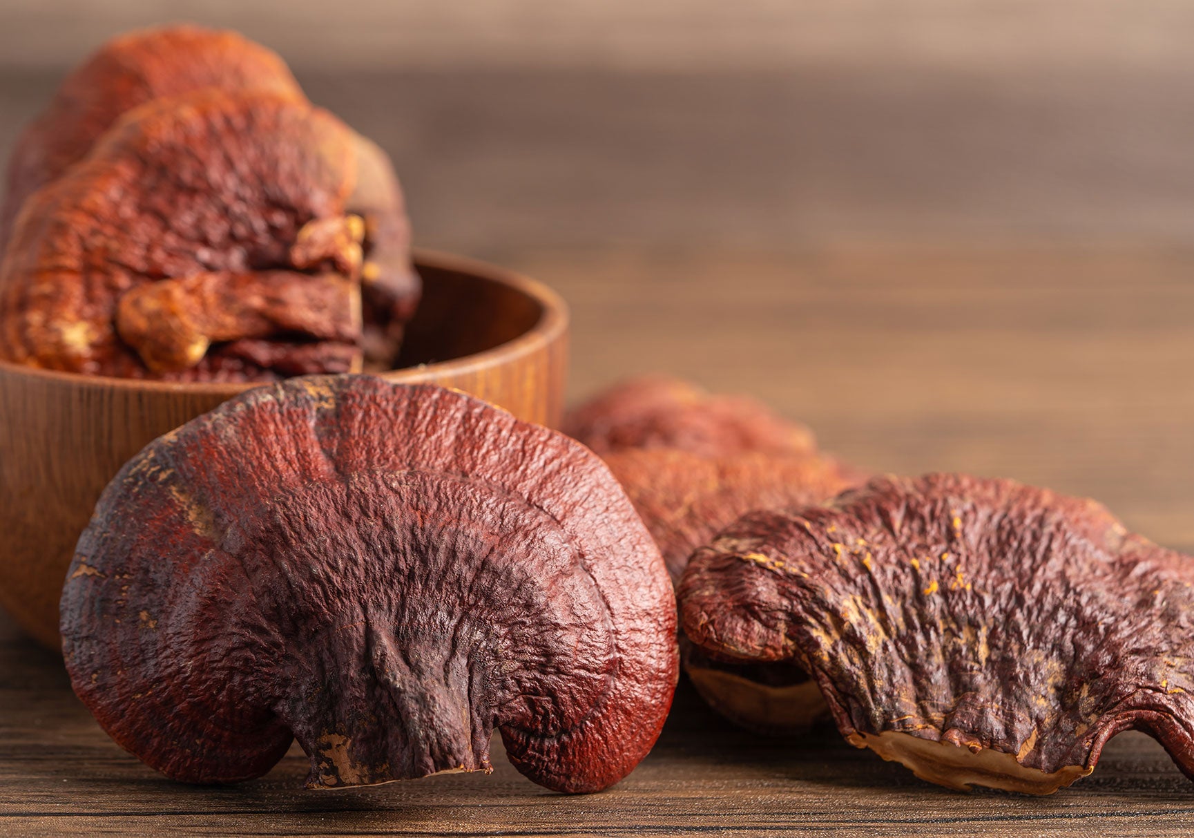 Dried lingzhi mushroom on wooden background.