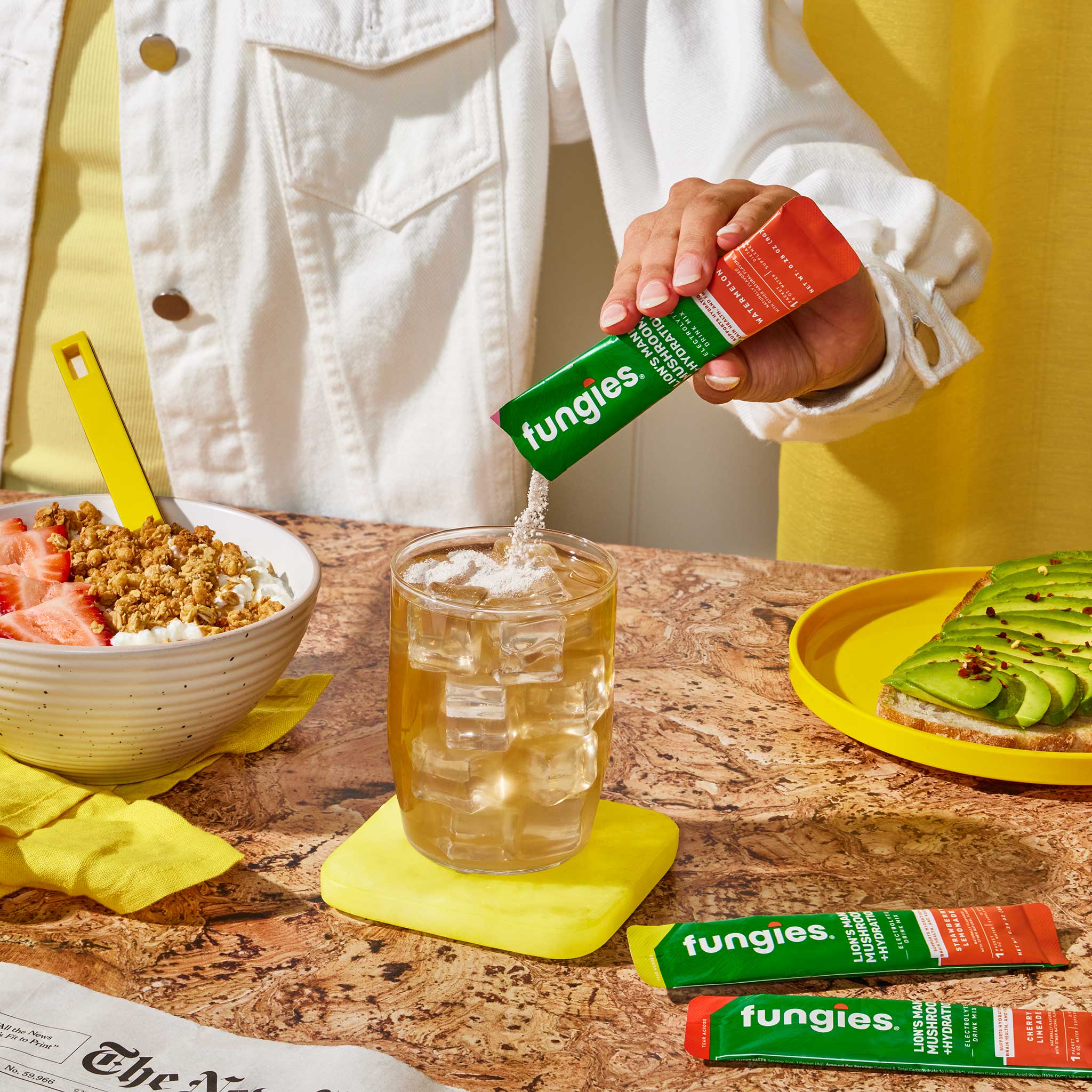 Lion's Mane Mushroom + Hydration (24 Count) displayed next to a glass with ice, showcasing its refreshing electrolyte-infused drink mix capabilities.